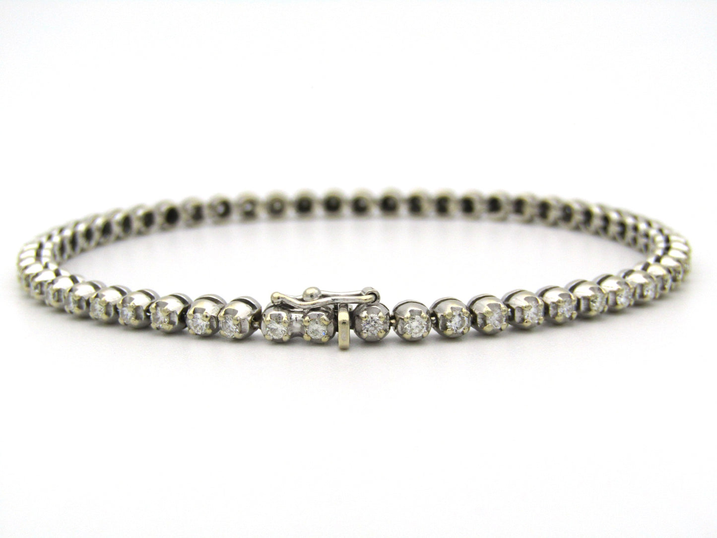 18K gold diamond tennis bracelet.