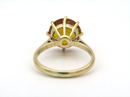 9K gold synthetic yellow sapphire ring.