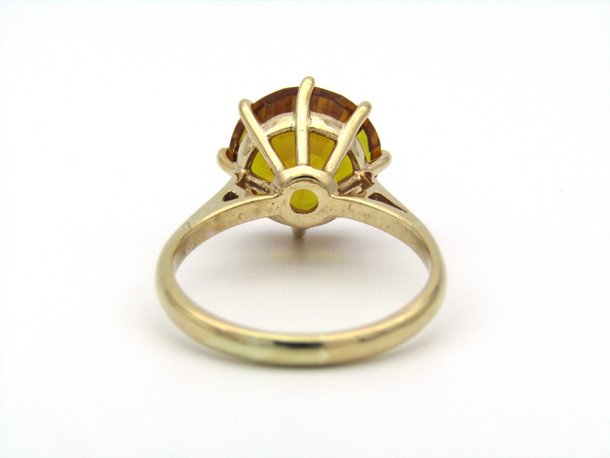 9K gold synthetic yellow sapphire ring.