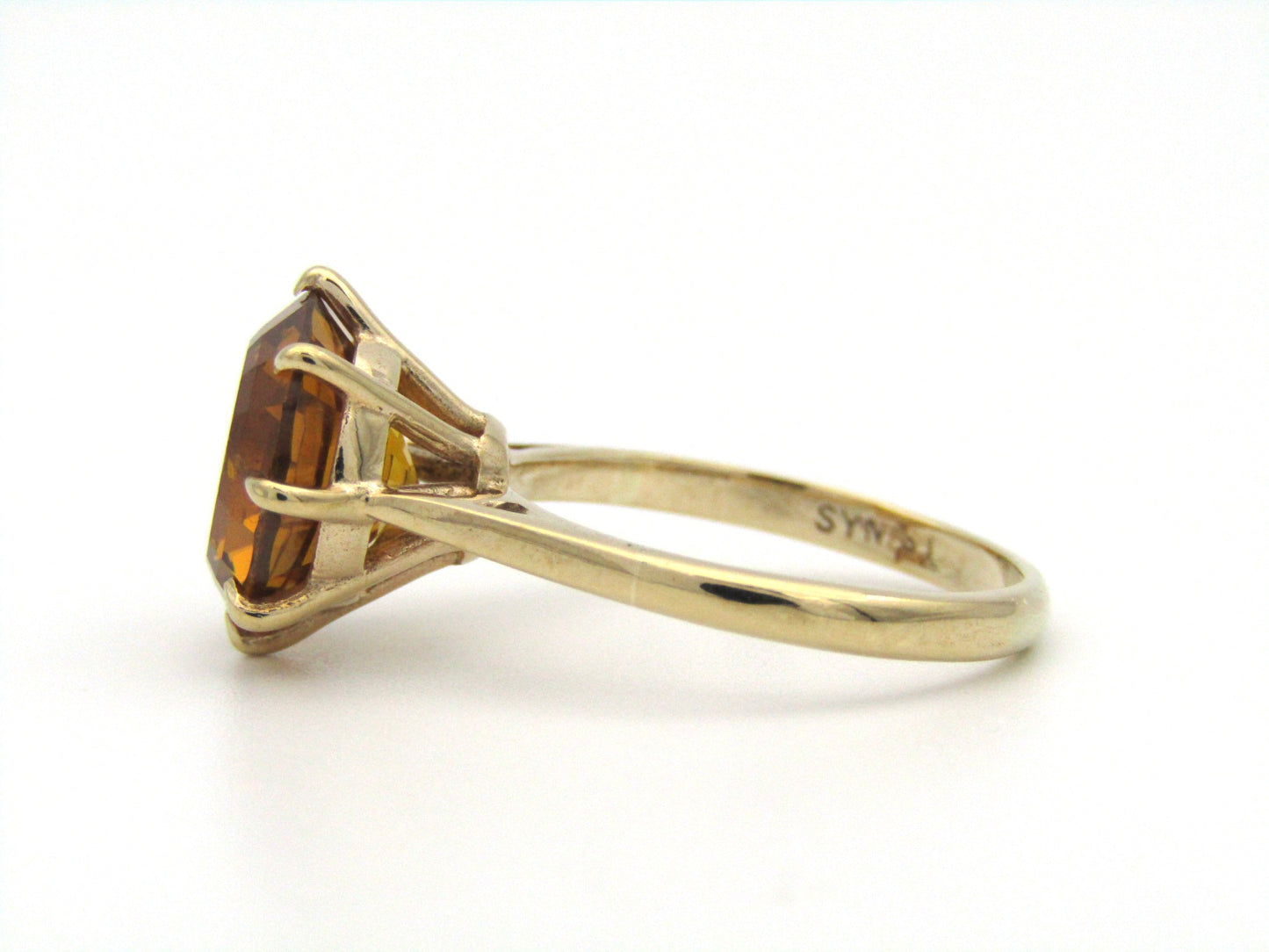 9K gold synthetic yellow sapphire ring.