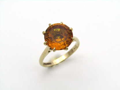 9K gold synthetic yellow sapphire ring.