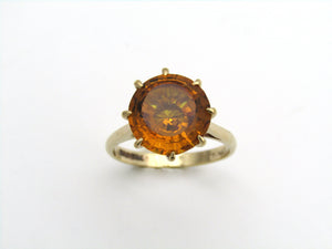 9K gold synthetic yellow sapphire ring.