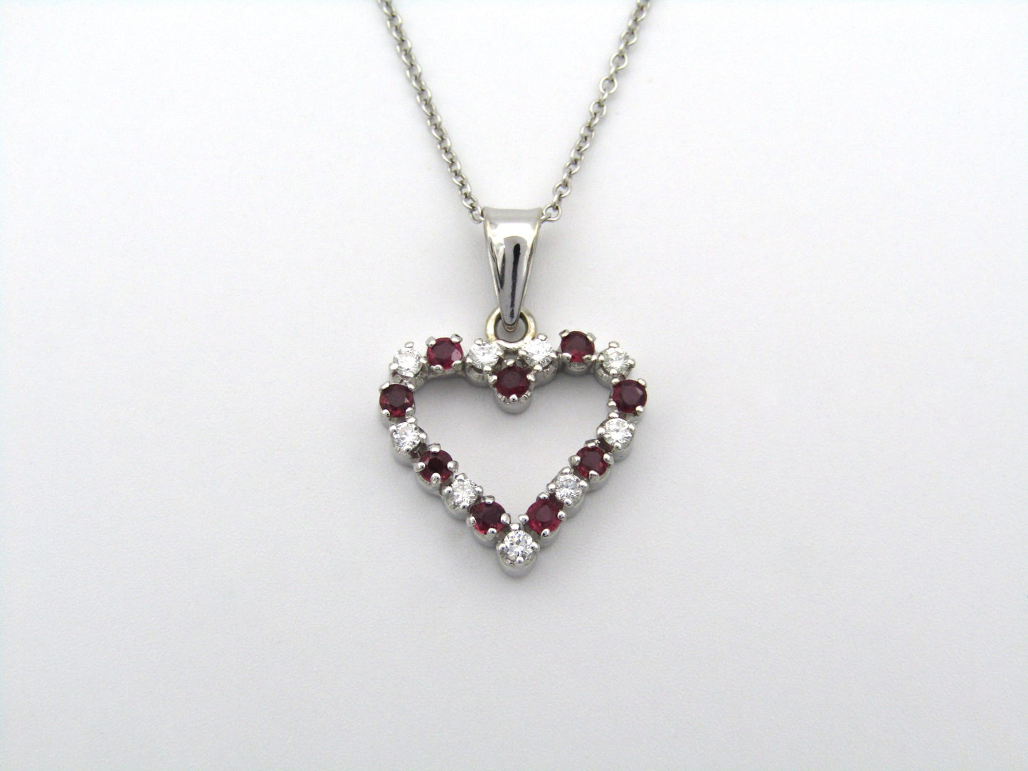 18K gold diamond and ruby heart pendant.