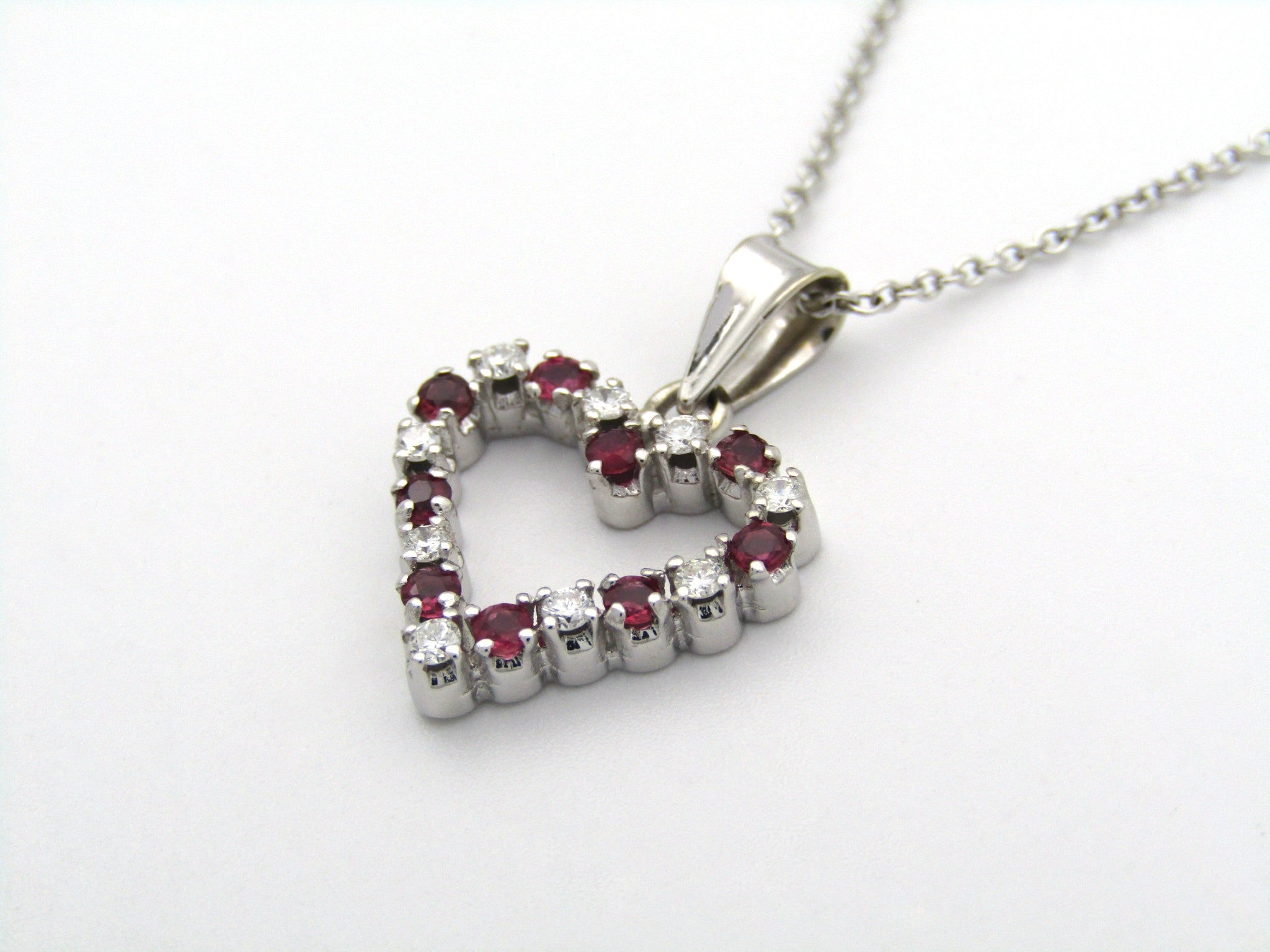 18K gold diamond and ruby heart pendant.