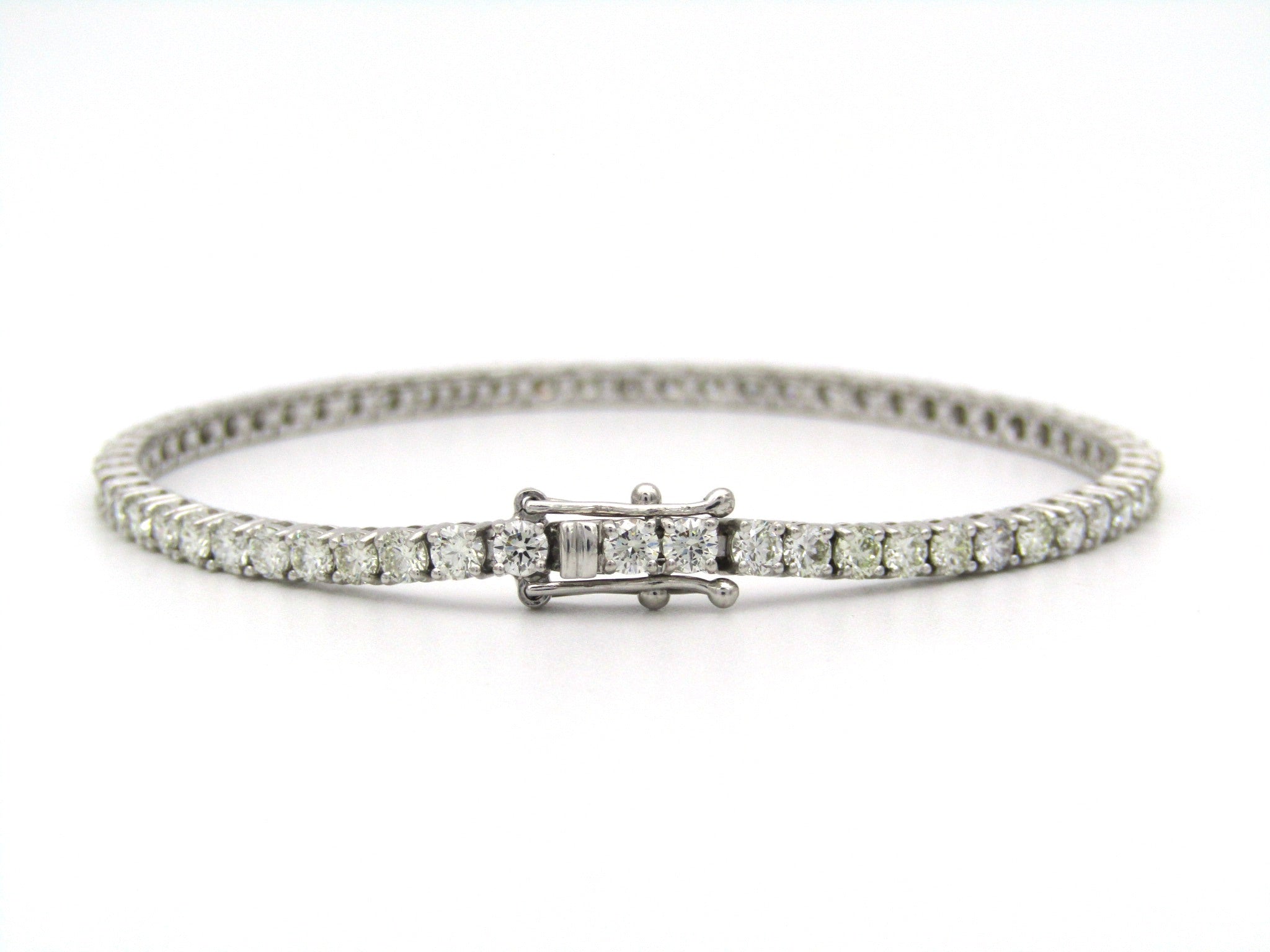 18K gold diamond tennis bracelet.