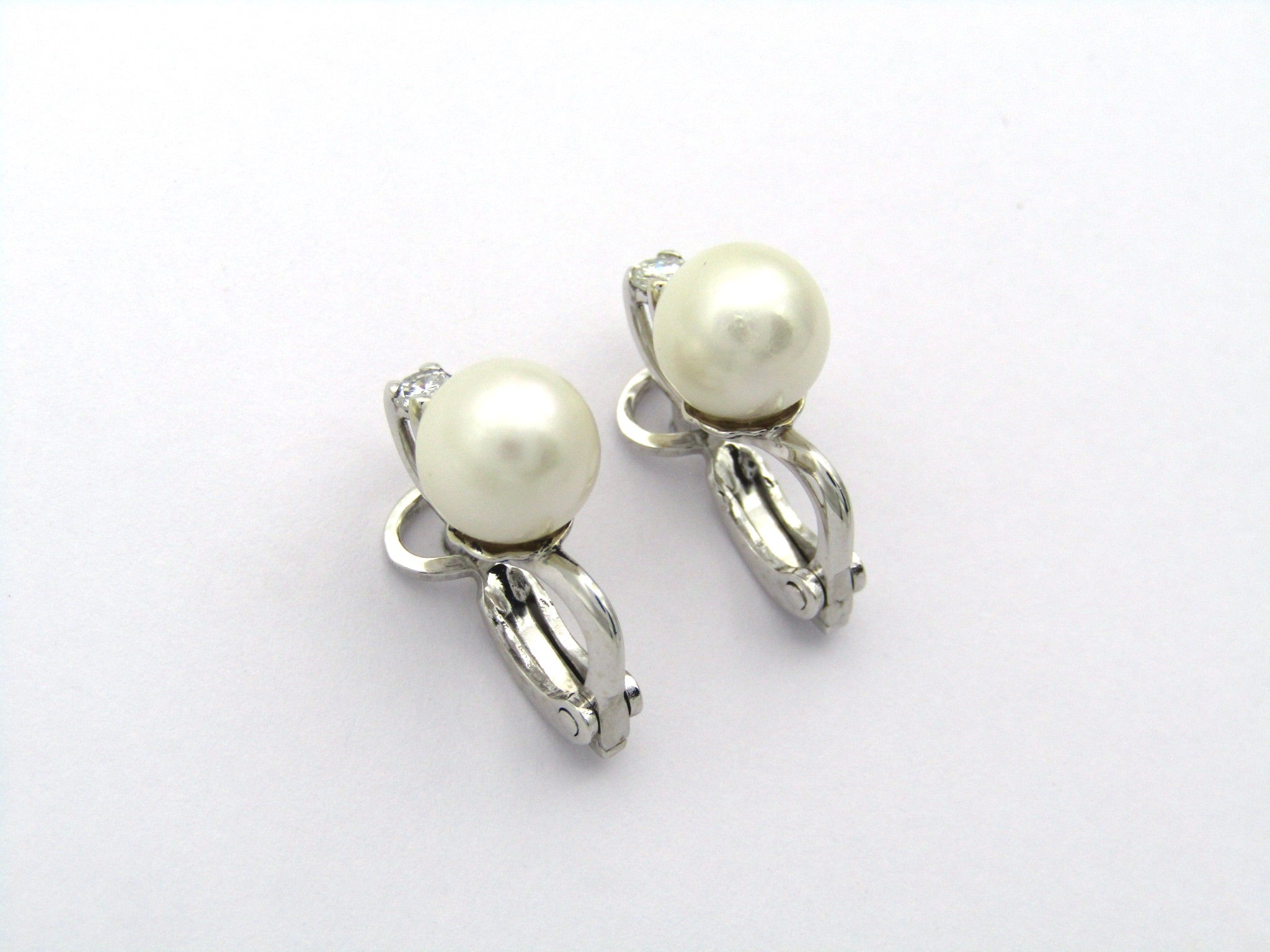 18K gold cultured pearl and diamond earrings.