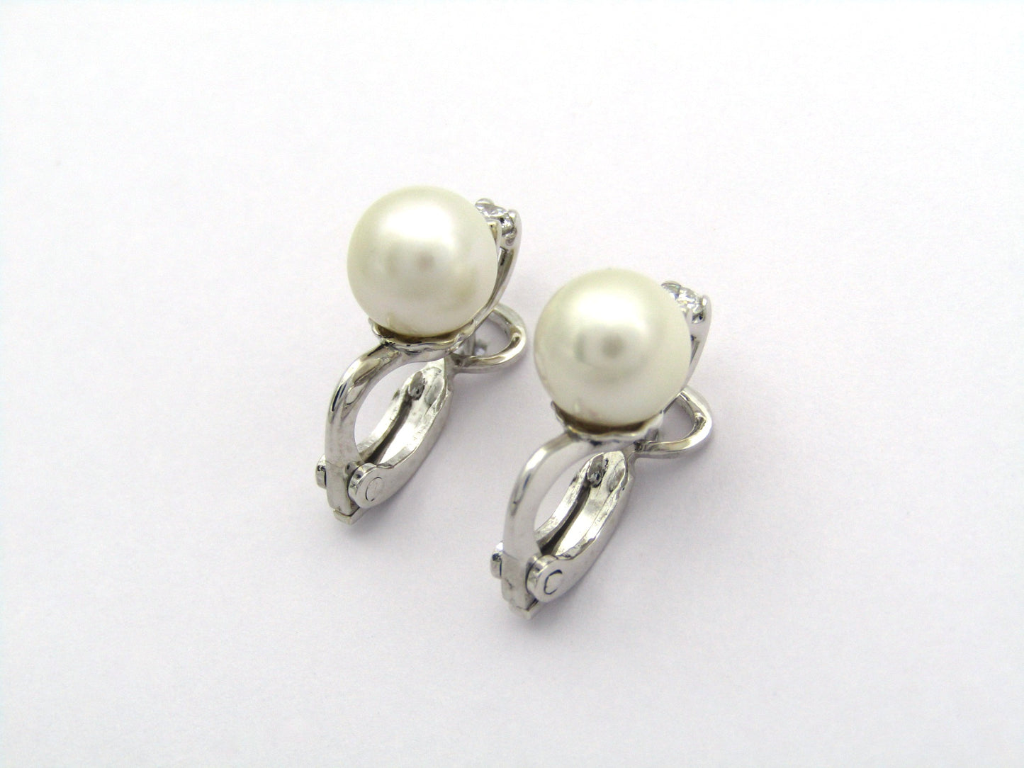 18K gold cultured pearl and diamond earrings.