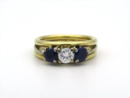 18K gold diamond and sapphire three-stone ring.