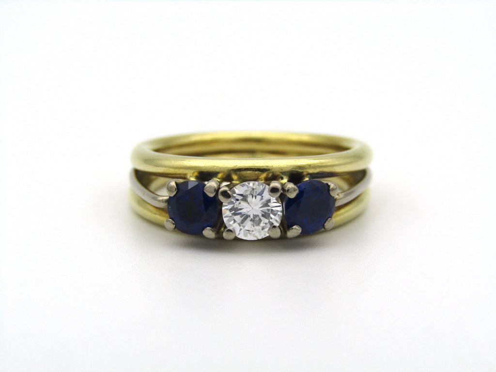 18K gold diamond and sapphire three-stone ring.