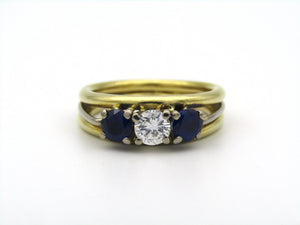 18K gold diamond and sapphire three-stone ring.