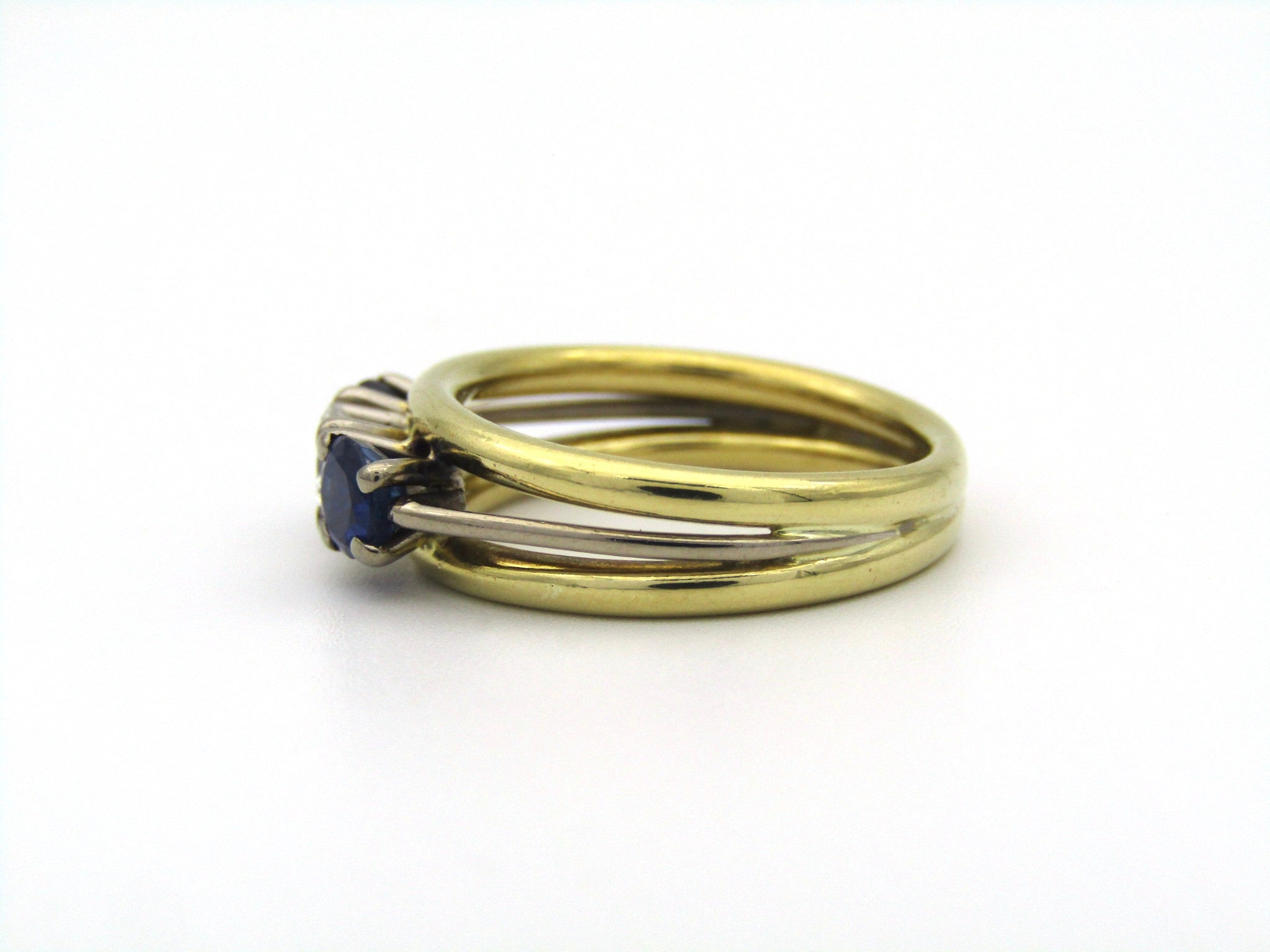 18K gold diamond and sapphire three-stone ring.