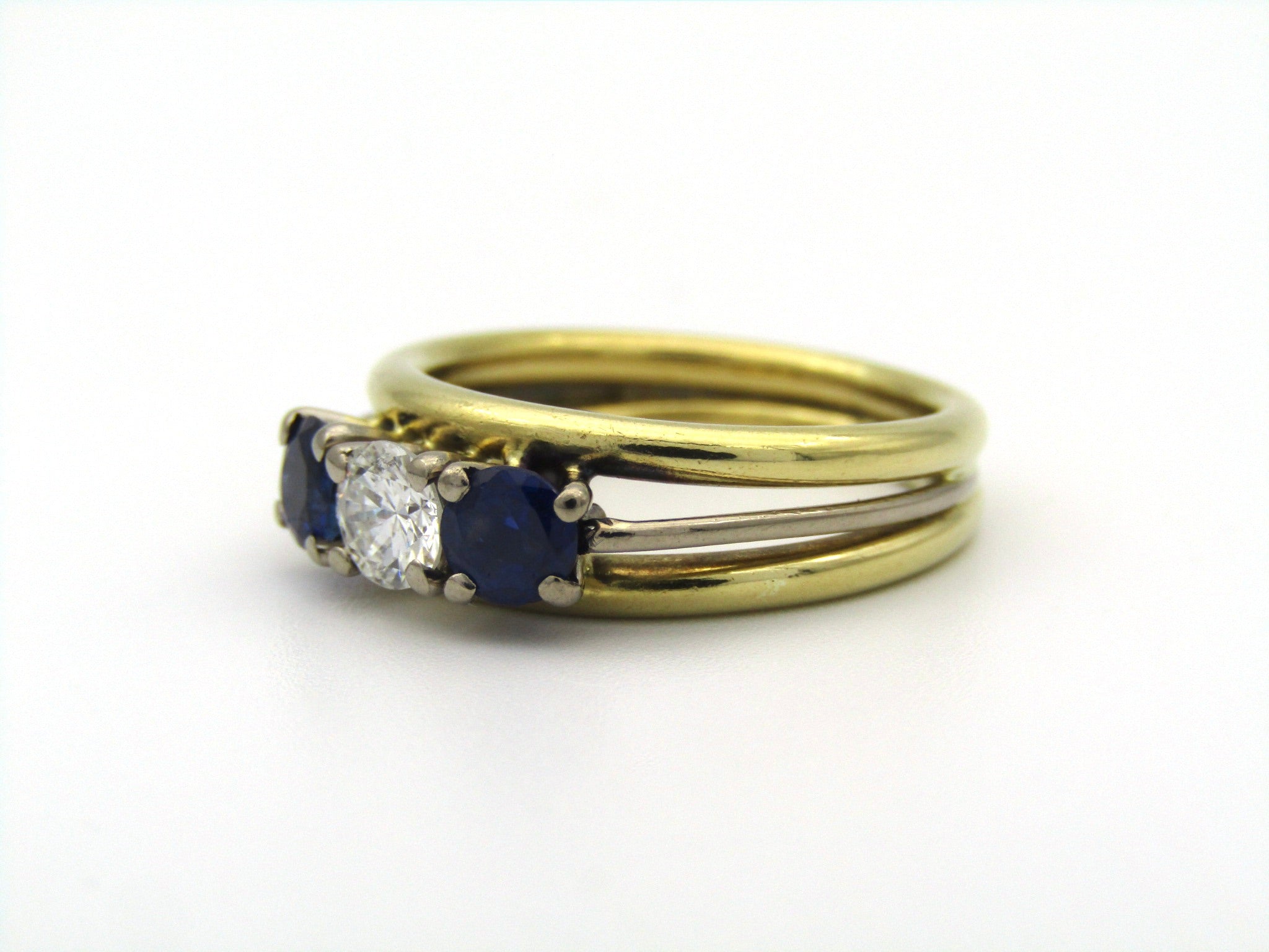 18K gold diamond and sapphire three-stone ring.