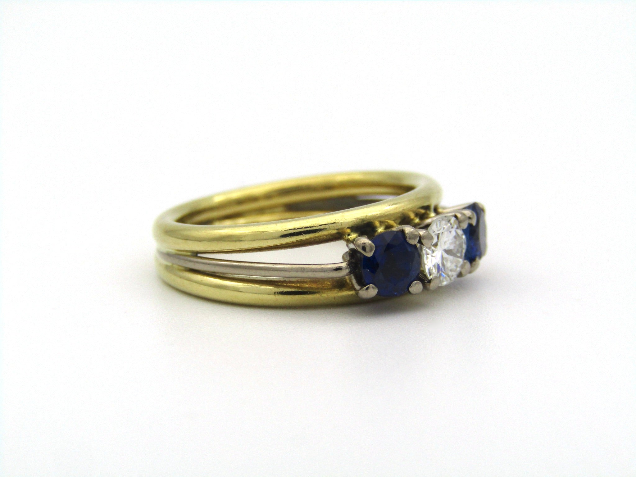 18K gold diamond and sapphire three-stone ring.