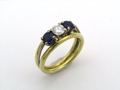 18K gold diamond and sapphire three-stone ring.