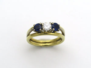 18K gold diamond and sapphire three-stone ring.