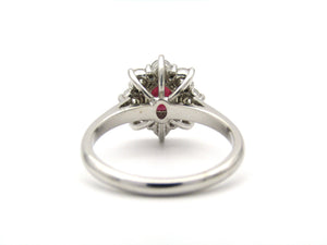 14K gold ruby and diamond halo ring.