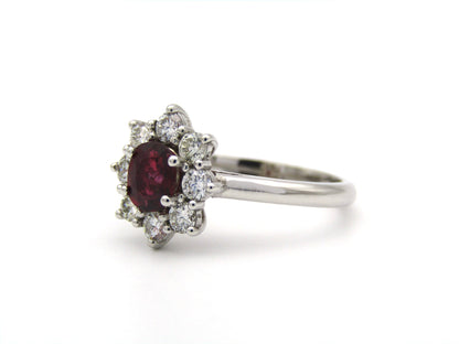 14K gold ruby and diamond halo ring.