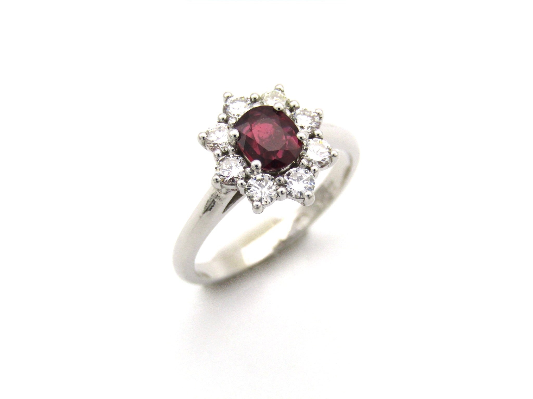 14K gold ruby and diamond halo ring.