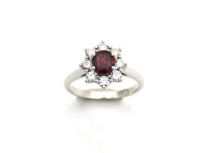 14K gold ruby and diamond halo ring.