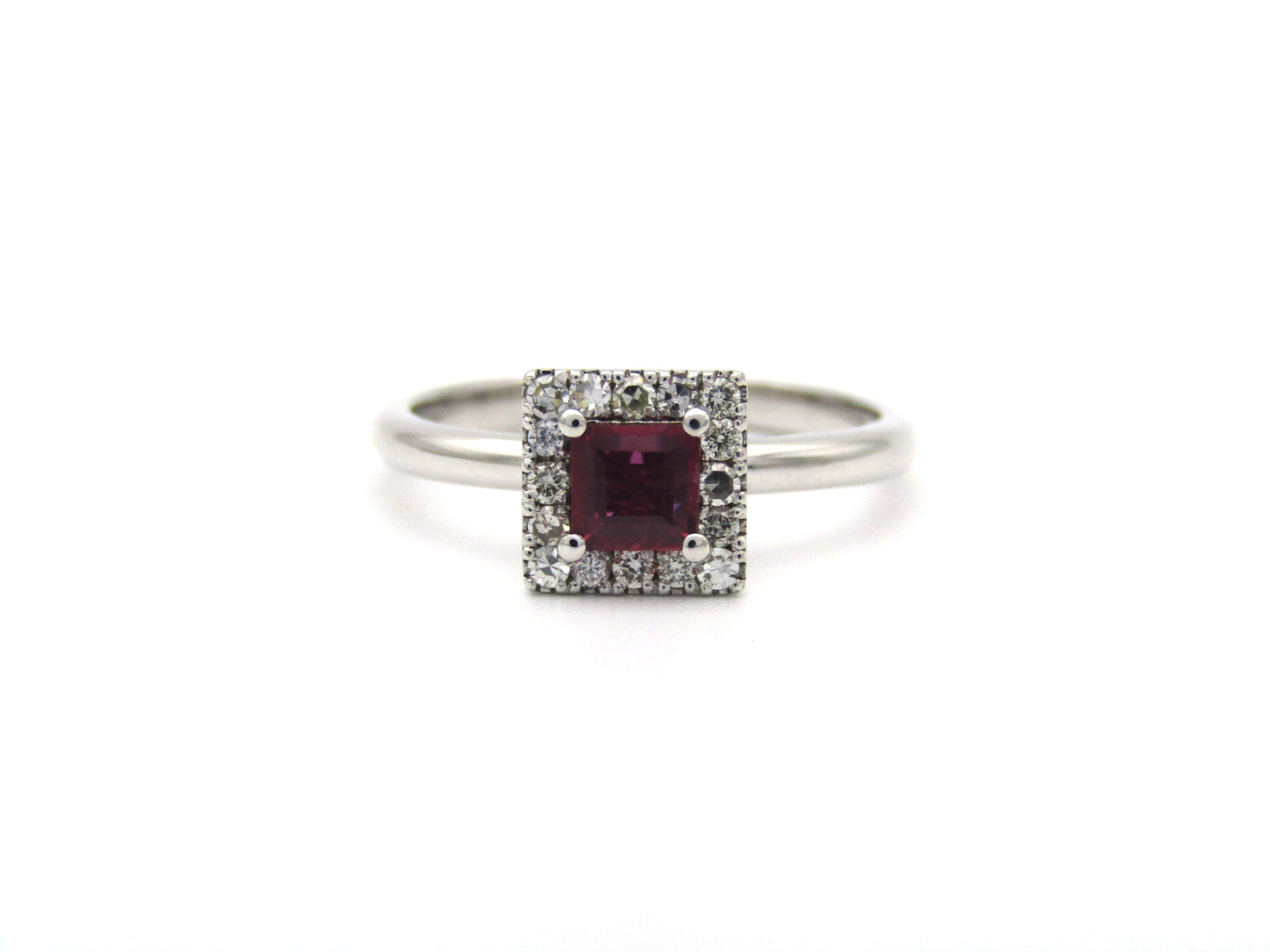 14K gold ruby and diamond halo ring.