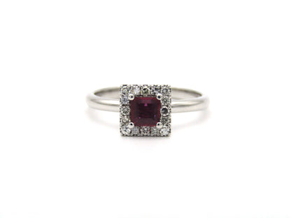 14K gold ruby and diamond halo ring.