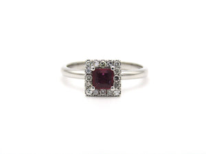 14K gold ruby and diamond halo ring.