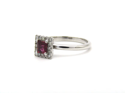 14K gold ruby and diamond halo ring.