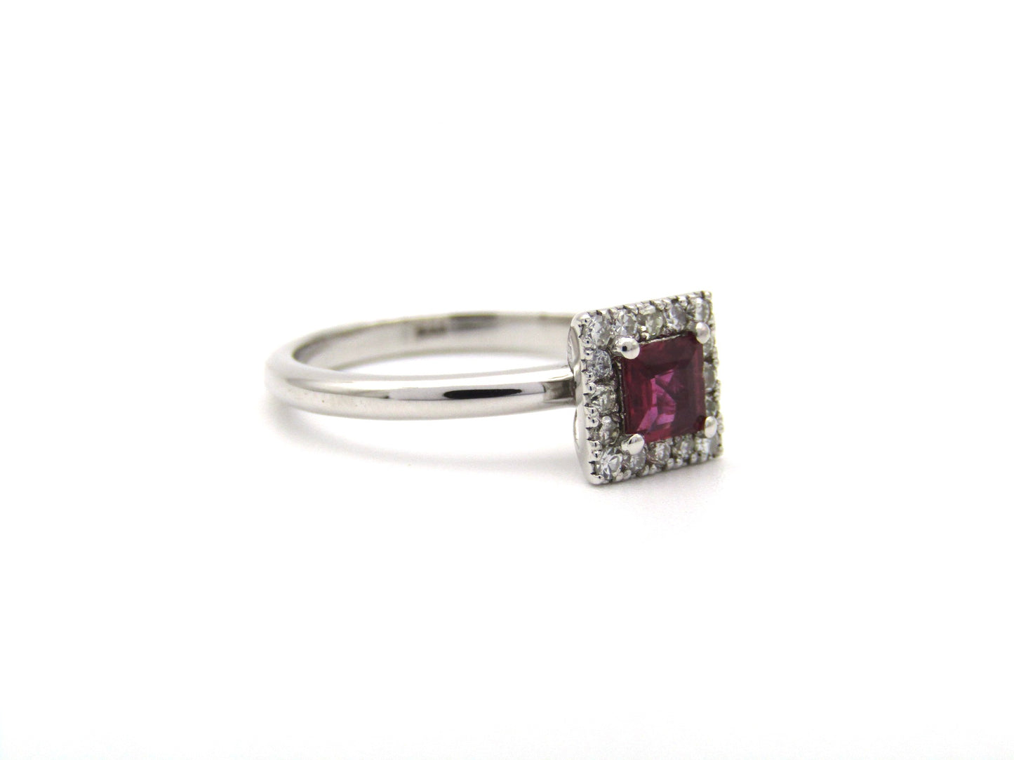 14K gold ruby and diamond halo ring.