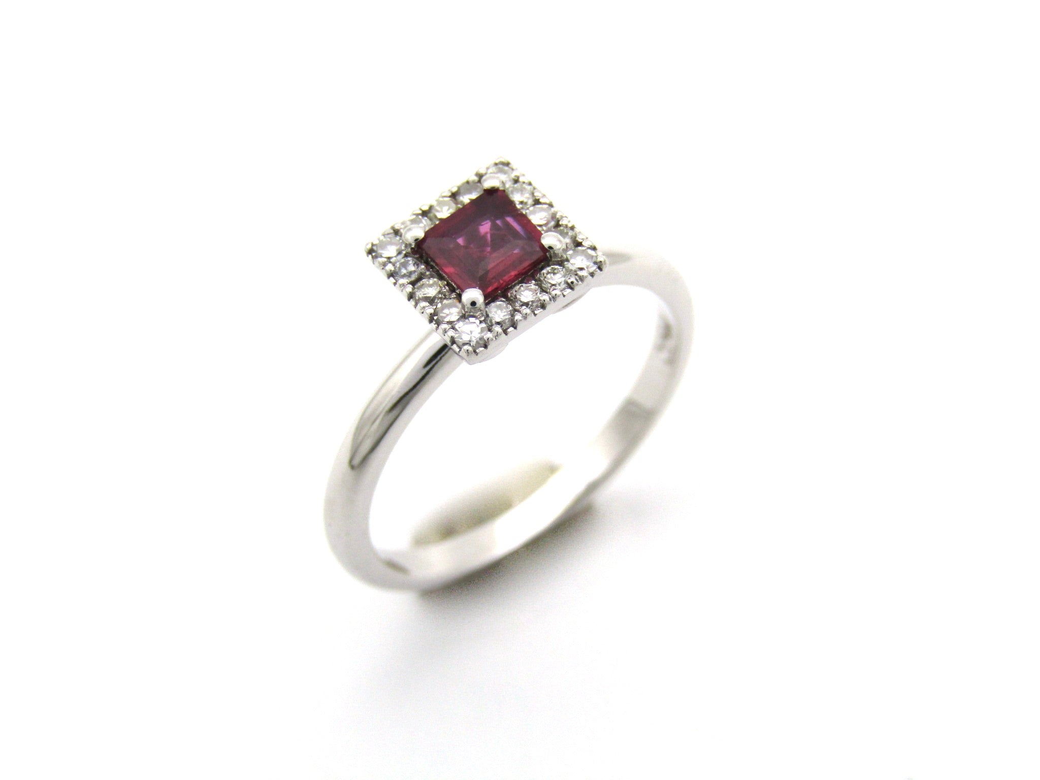 14K gold ruby and diamond halo ring.