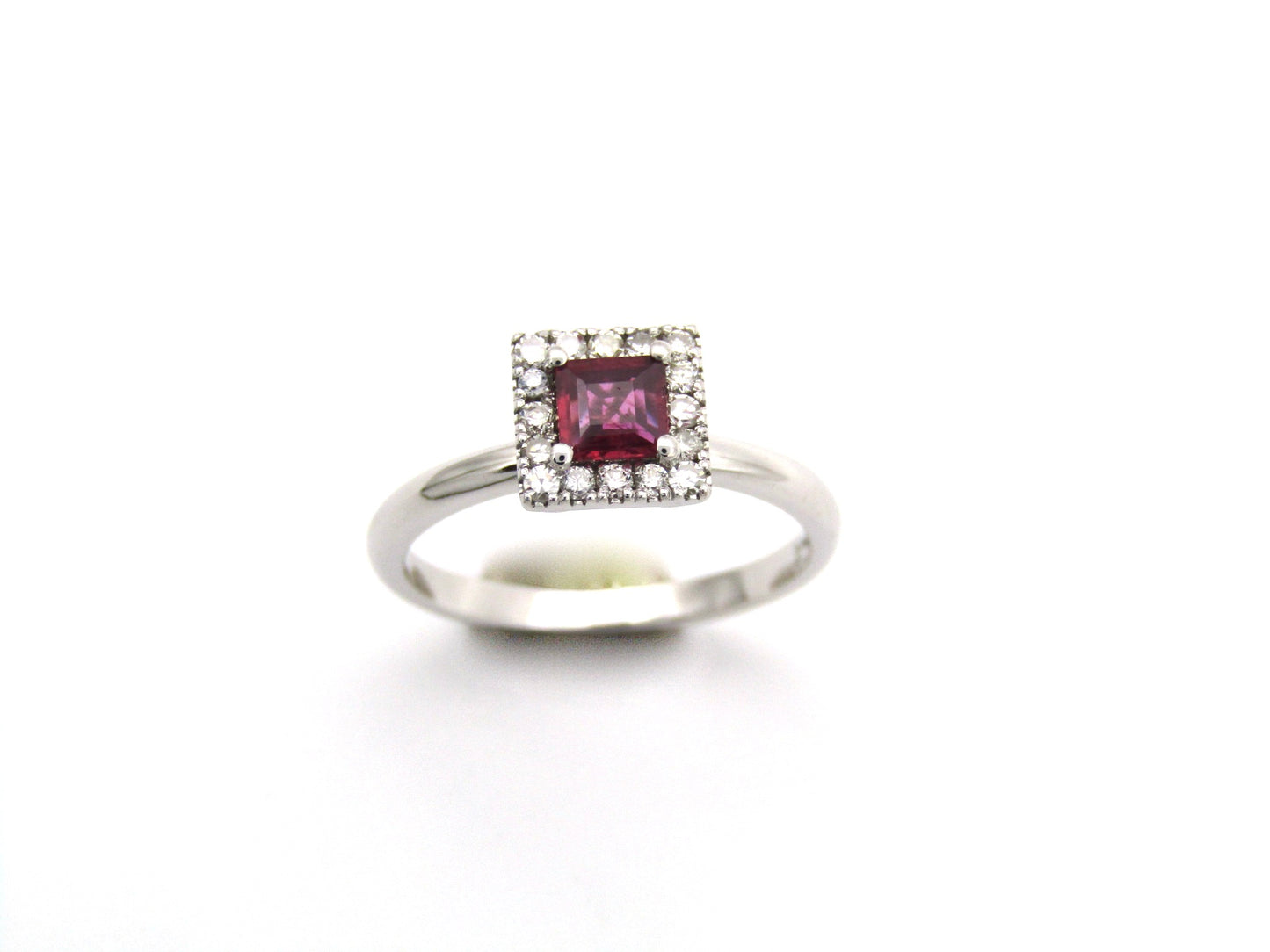 14K gold ruby and diamond halo ring.