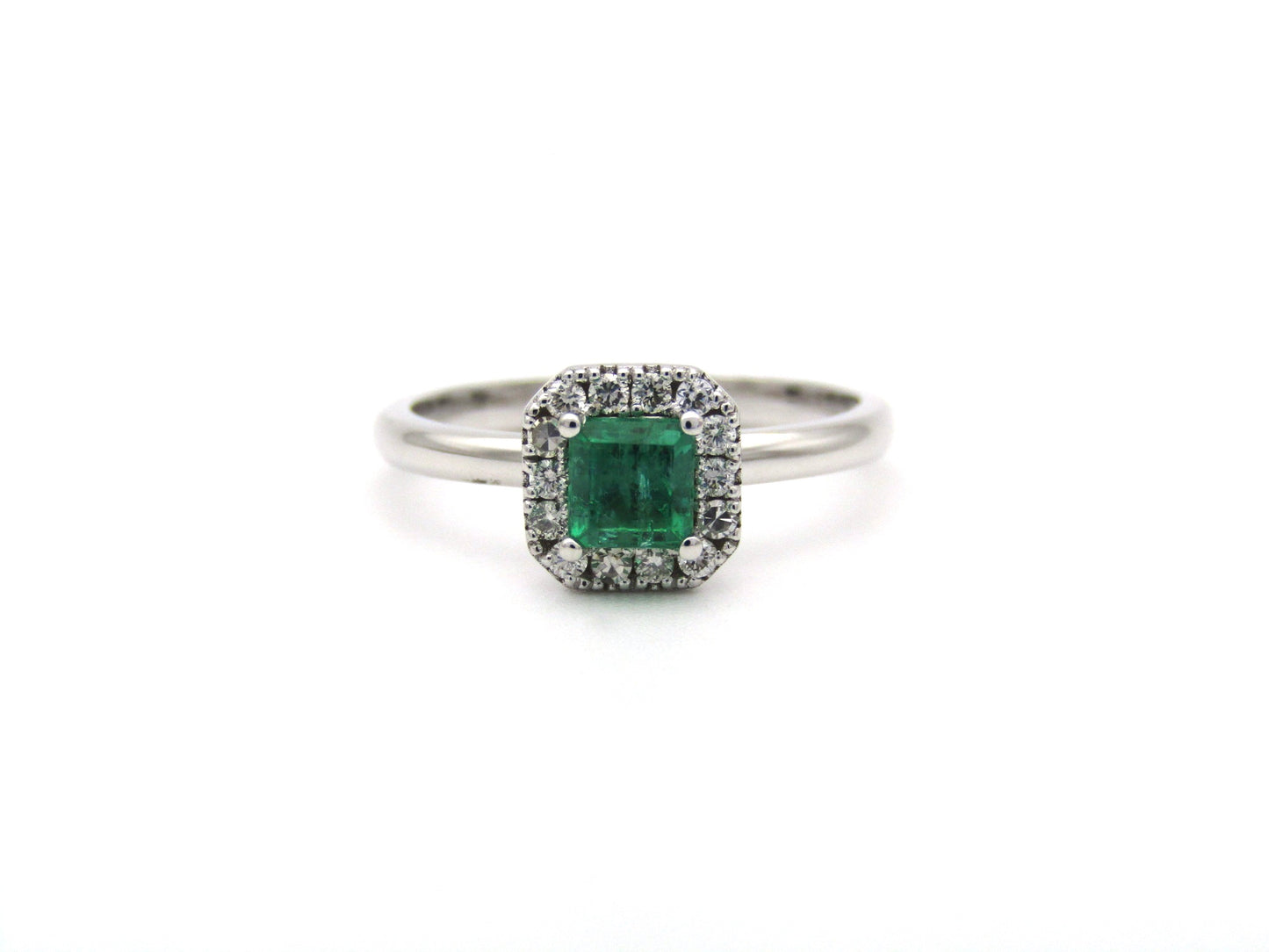 14K gold emerald and diamond halo ring.