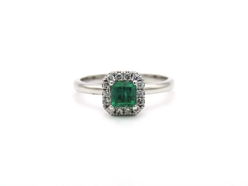 14K gold emerald and diamond halo ring.