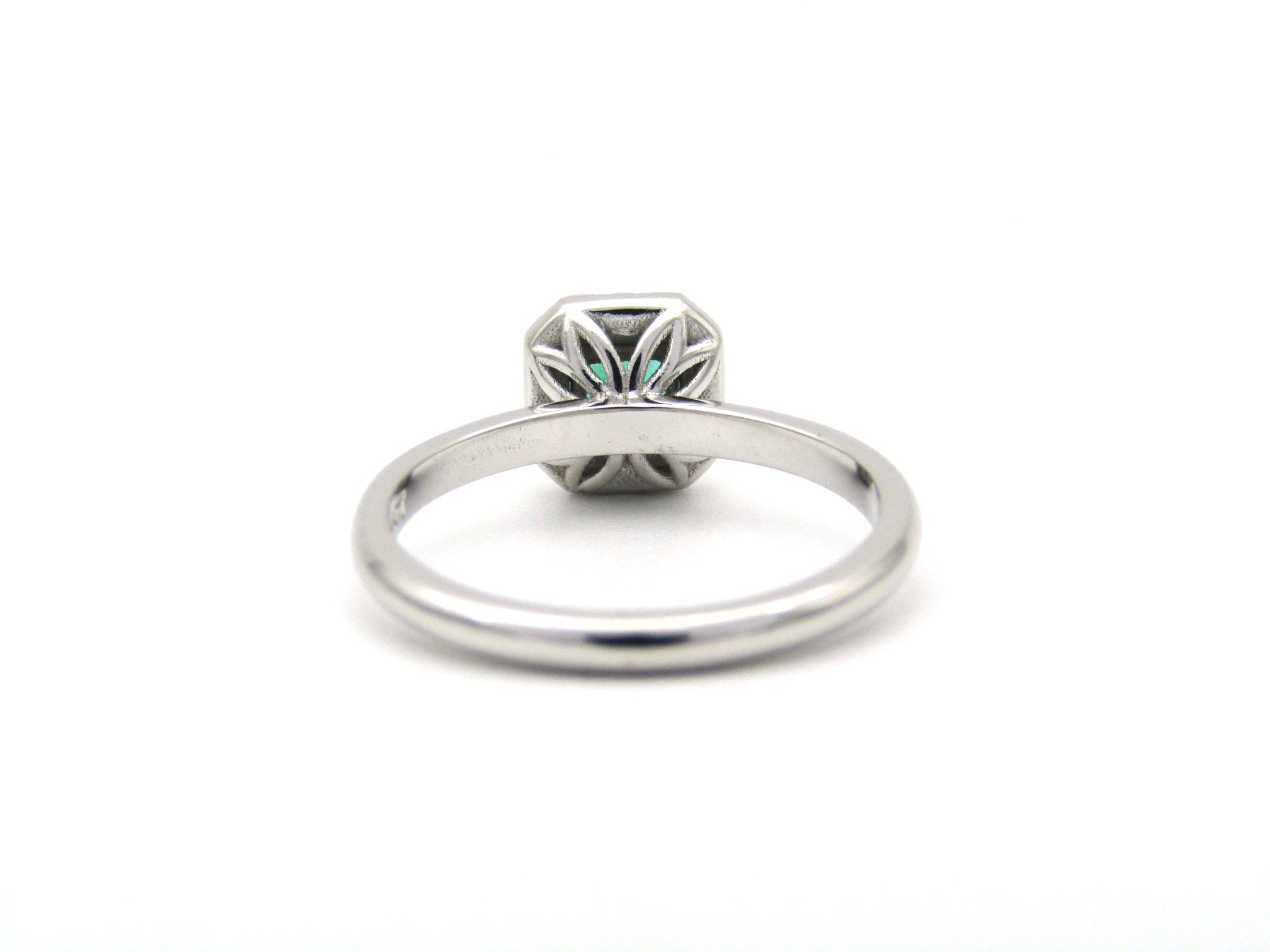 14K gold emerald and diamond halo ring.