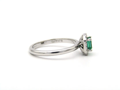 14K gold emerald and diamond halo ring.