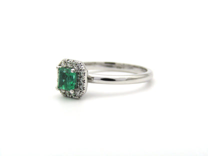 14K gold emerald and diamond halo ring.