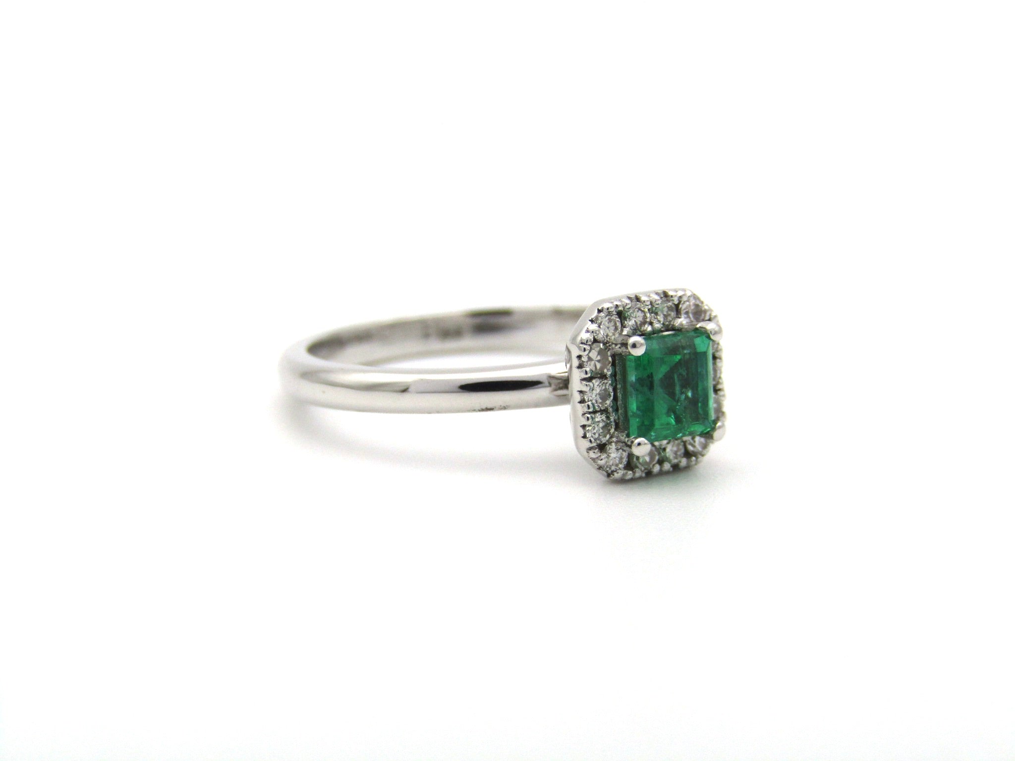 14K gold emerald and diamond halo ring.