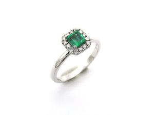 14K gold emerald and diamond halo ring.