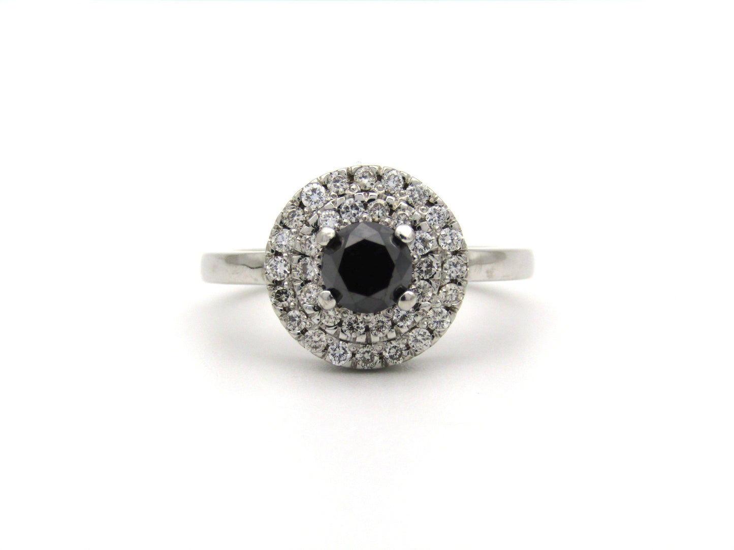 18K gold black and colourless diamond halo ring.