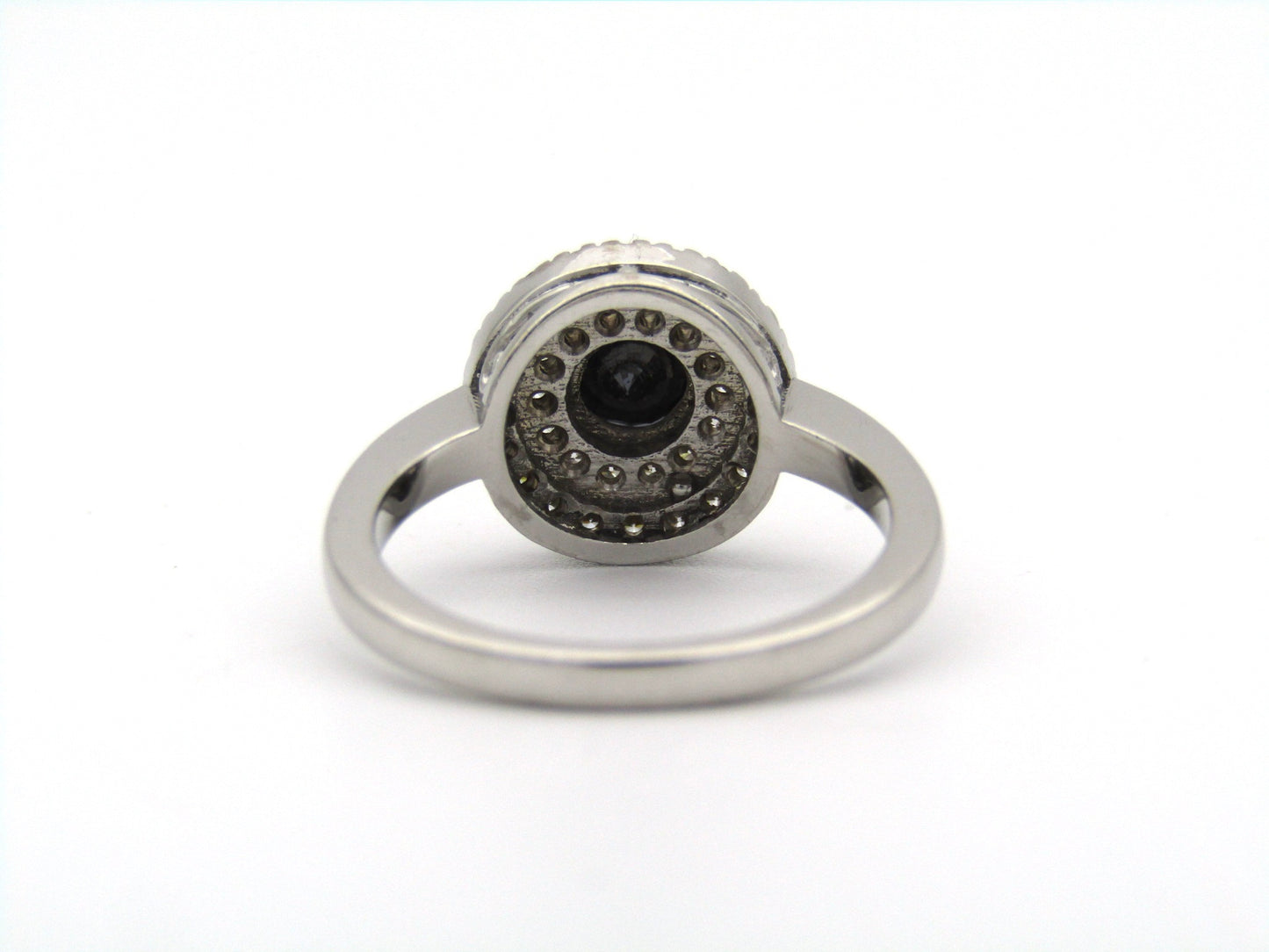 18K gold black and colourless diamond halo ring.