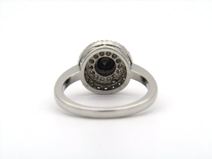 18K gold black and colourless diamond halo ring.