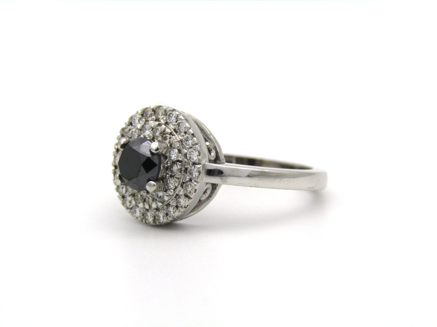 18K gold black and colourless diamond halo ring.