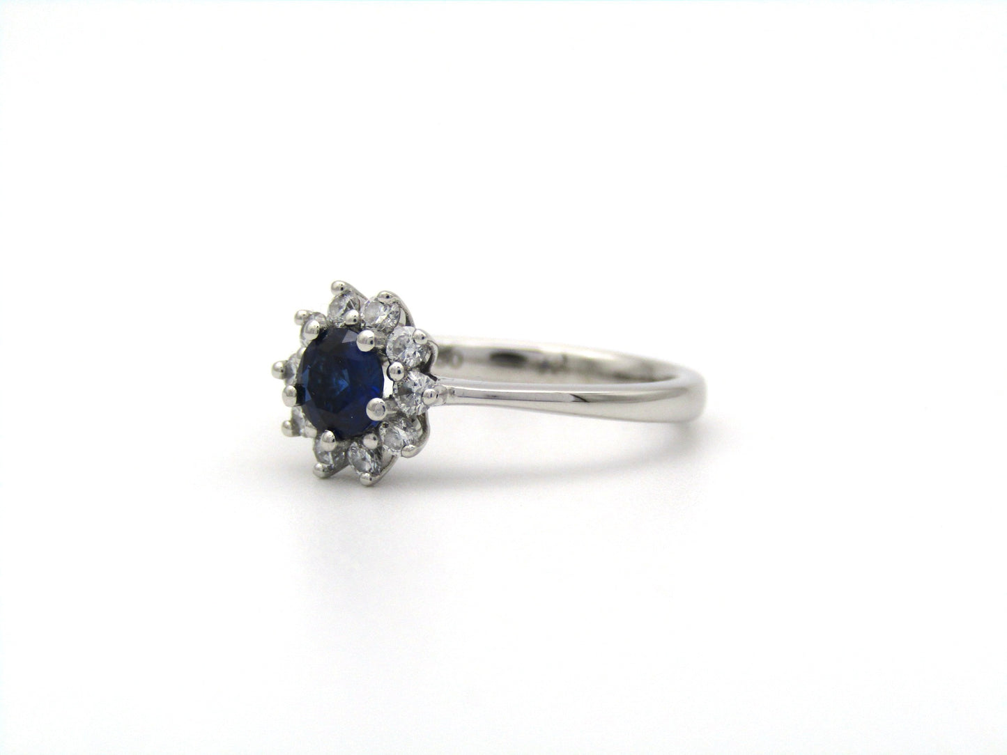 18K gold sapphire and diamond halo ring.