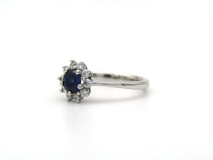 18K gold sapphire and diamond halo ring.