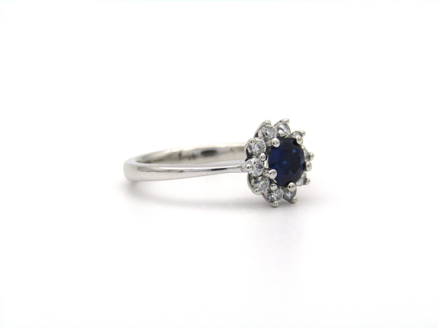 18K gold sapphire and diamond halo ring.