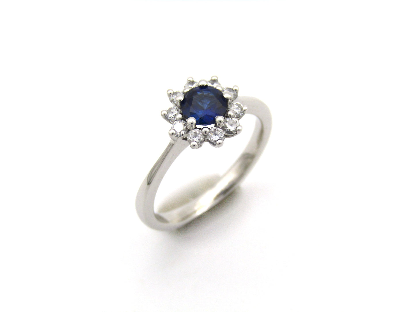 18K gold sapphire and diamond halo ring.