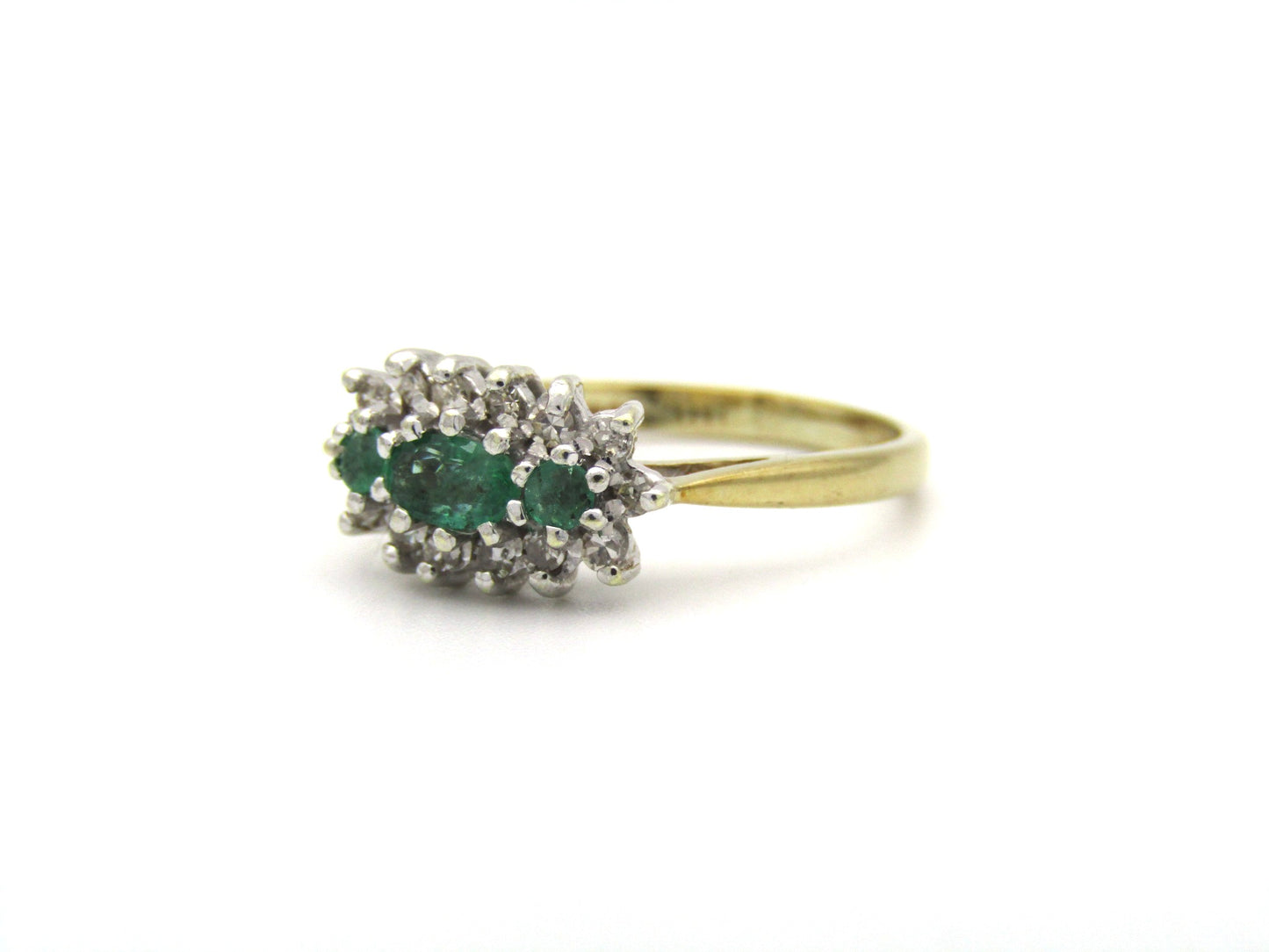 9K gold emerald and diamond ring.