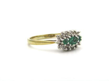 9K gold emerald and diamond ring.