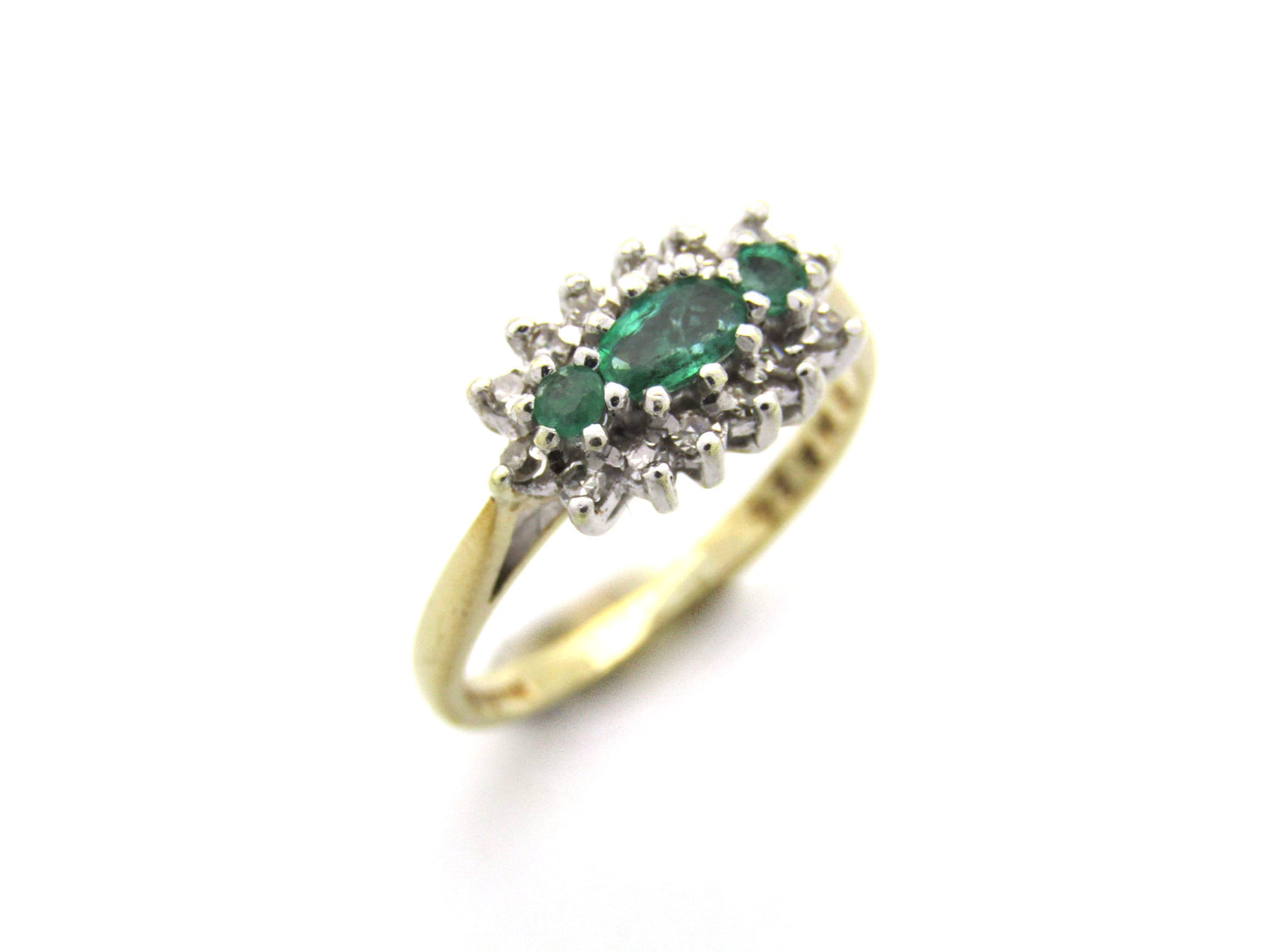 9K gold emerald and diamond ring.