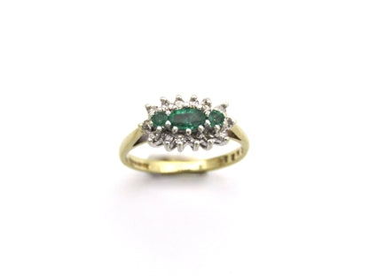 9K gold emerald and diamond ring.