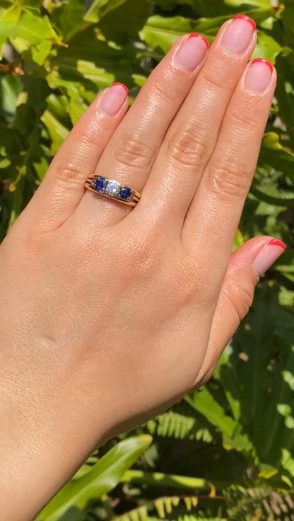 18K gold diamond and sapphire three-stone ring.